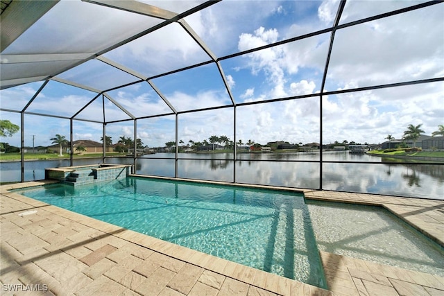 view of pool with an in ground hot tub, glass enclosure, a water view, and a patio area