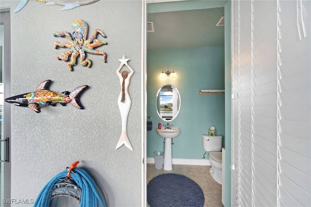 bathroom with tile patterned floors and toilet