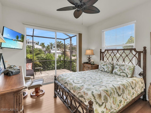 bedroom with hardwood / wood-style floors, access to exterior, and ceiling fan