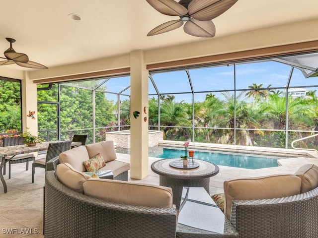 exterior space with an outdoor living space, glass enclosure, and ceiling fan