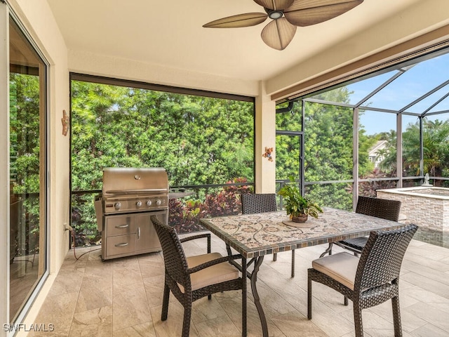 sunroom featuring ceiling fan