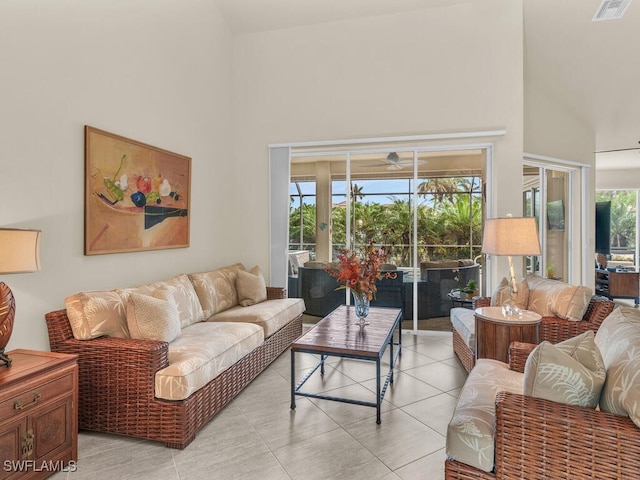 tiled living room with a healthy amount of sunlight and high vaulted ceiling