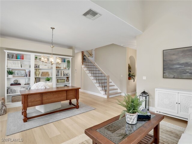 living room featuring a notable chandelier and hardwood / wood-style floors