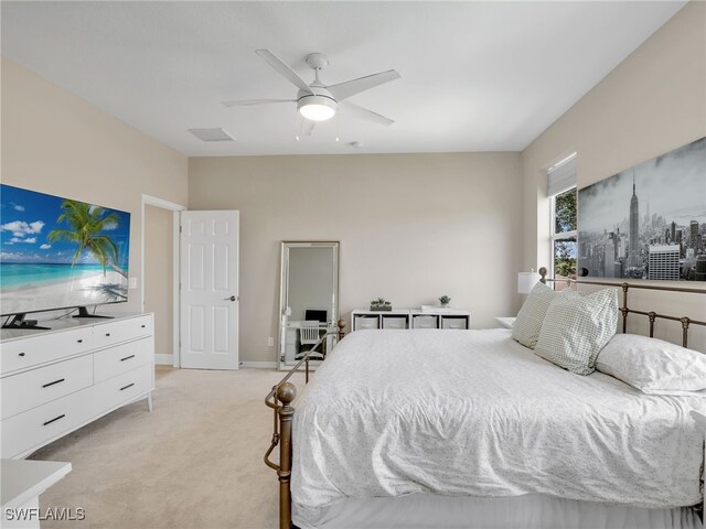 bedroom with light carpet and ceiling fan