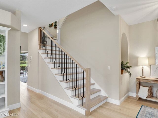 stairway with hardwood / wood-style flooring