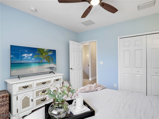 bedroom with ceiling fan and a closet