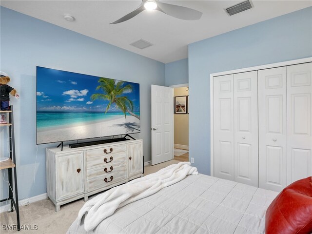 bedroom featuring a closet, ceiling fan, and light colored carpet