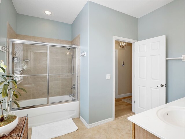 bathroom featuring combined bath / shower with glass door, vanity, and tile patterned floors