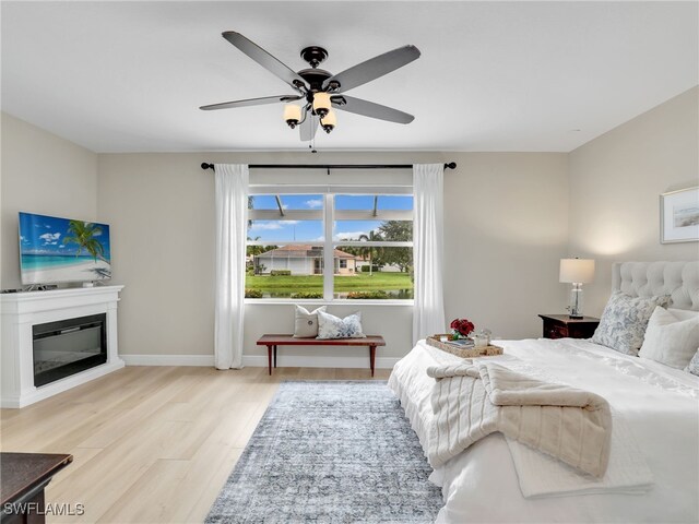 bedroom with wood-type flooring and ceiling fan