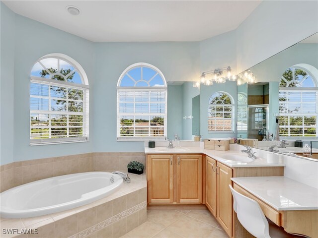 bathroom with tile patterned floors, vanity, plus walk in shower, and plenty of natural light