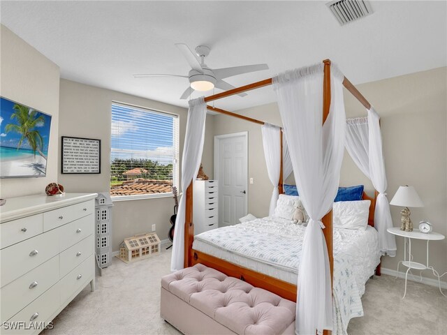 bedroom featuring ceiling fan and light colored carpet