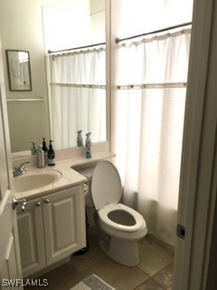 full bathroom featuring shower / bathtub combination with curtain, tile patterned flooring, vanity, and toilet