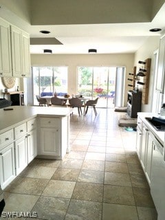 kitchen featuring kitchen peninsula and white cabinetry