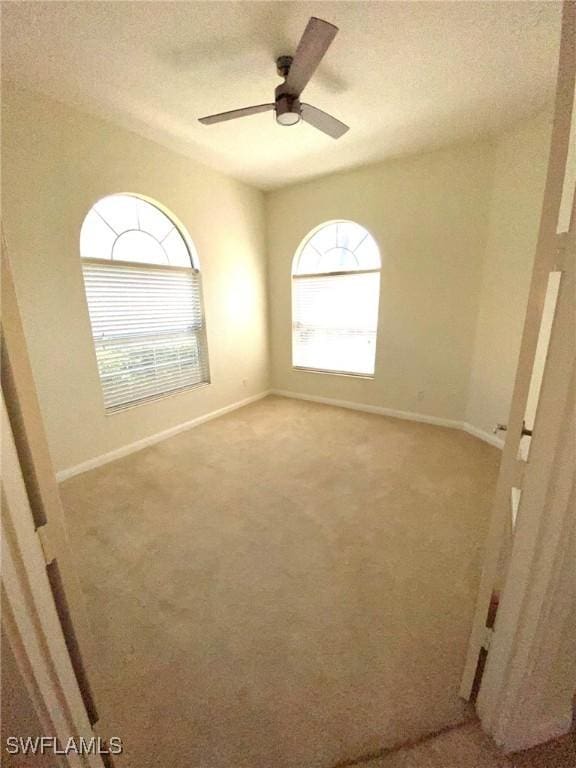 7617 Garibaldi Ct, Naples, FL 34114 - spare room with light colored carpet, baseboards, and ceiling fan