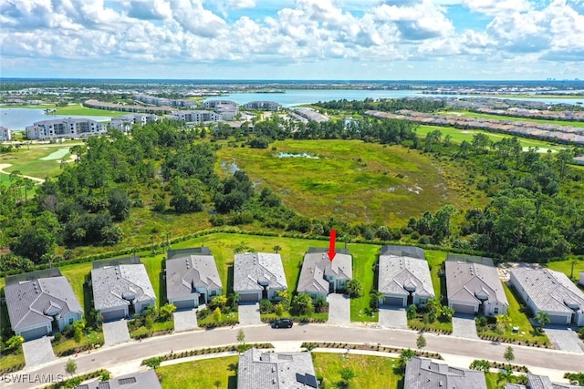 aerial view of residential area featuring a nearby body of water