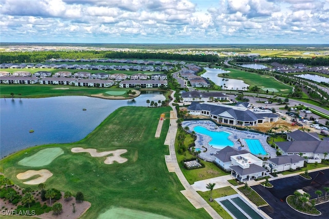 aerial view of residential area featuring a nearby body of water, a pool area, and a golf club