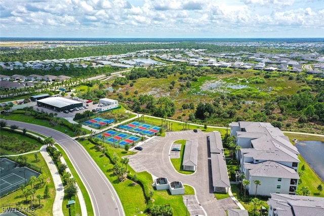 aerial perspective of suburban area with a nearby body of water