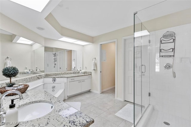 bathroom with tile patterned floors, vanity, a skylight, and an enclosed shower