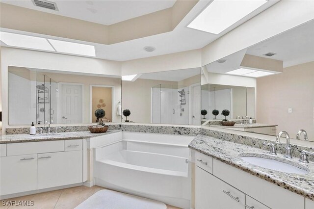 bathroom featuring tile patterned floors, vanity, and separate shower and tub