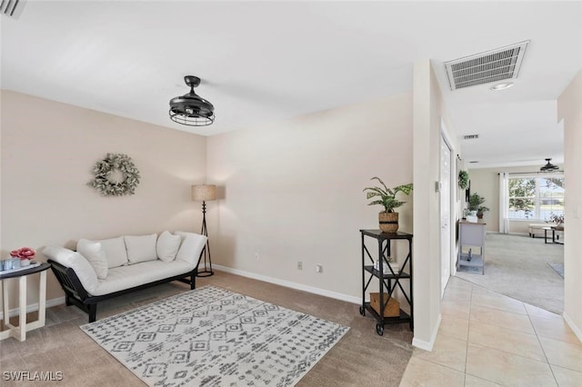 sitting room featuring ceiling fan and light colored carpet