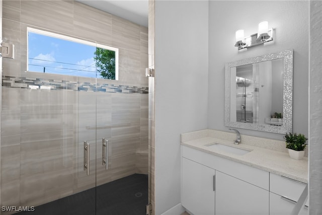 bathroom featuring vanity and a shower with shower door