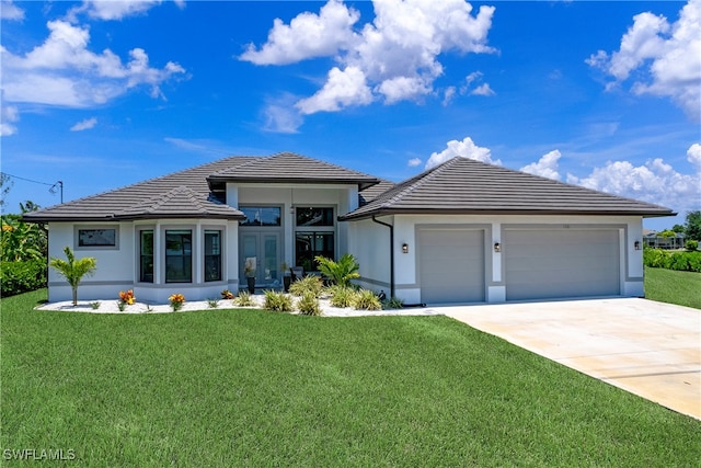 view of front of home with a garage and a front lawn