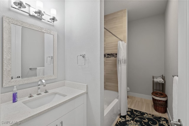 full bathroom with shower / tub combo, vanity, and toilet