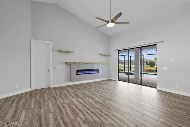 unfurnished living room with ceiling fan, high vaulted ceiling, and hardwood / wood-style flooring