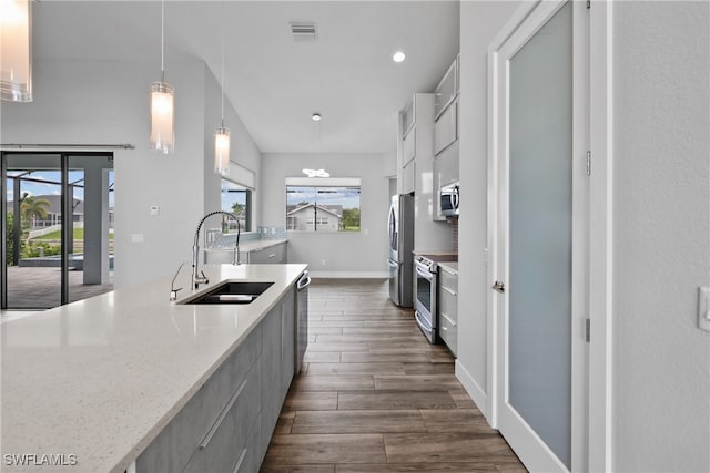 kitchen with pendant lighting, a healthy amount of sunlight, dark hardwood / wood-style flooring, and sink