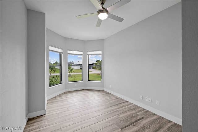 unfurnished room featuring ceiling fan and light hardwood / wood-style floors