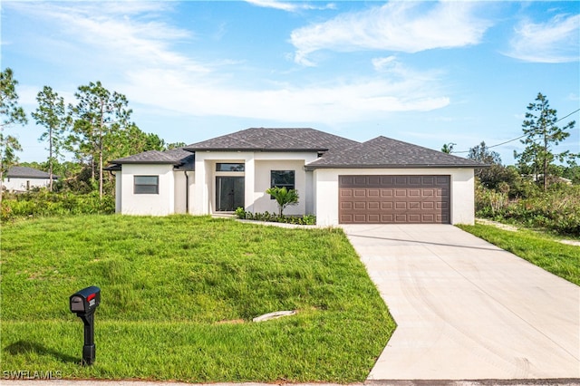 view of front of home with a garage and a front lawn