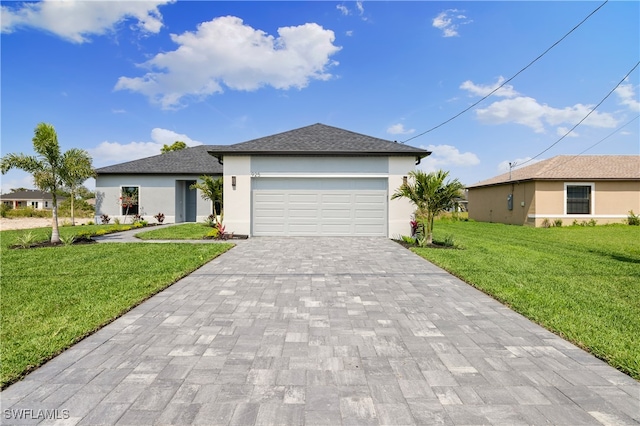 view of front of property with a garage and a front yard