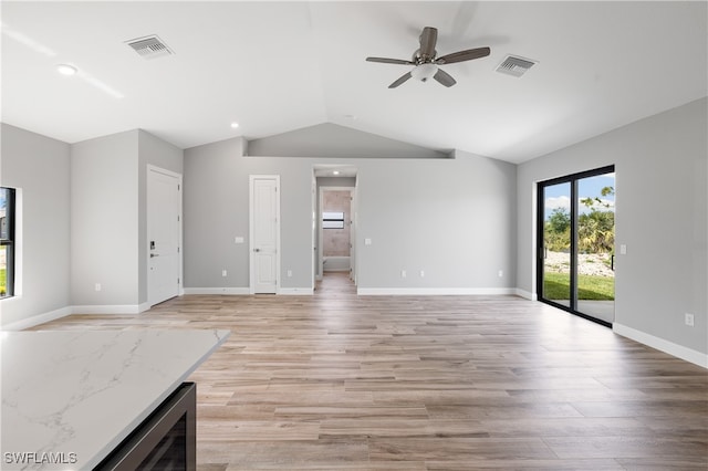 unfurnished living room featuring light wood-type flooring, vaulted ceiling, beverage cooler, and ceiling fan