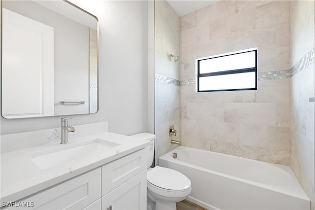 full bathroom with vanity, toilet, and tiled shower / bath