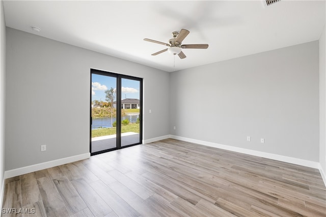 spare room with light hardwood / wood-style floors and ceiling fan