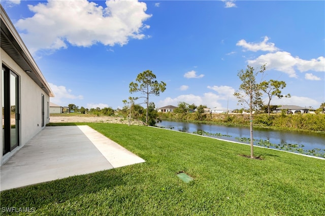 view of yard featuring a patio and a water view