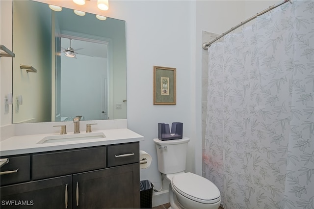 bathroom with ceiling fan, walk in shower, vanity, and toilet