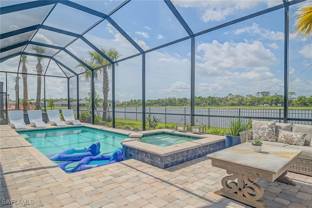 view of pool with a patio, an in ground hot tub, and a lanai