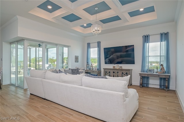 living room featuring crown molding, light hardwood / wood-style flooring, and a wealth of natural light