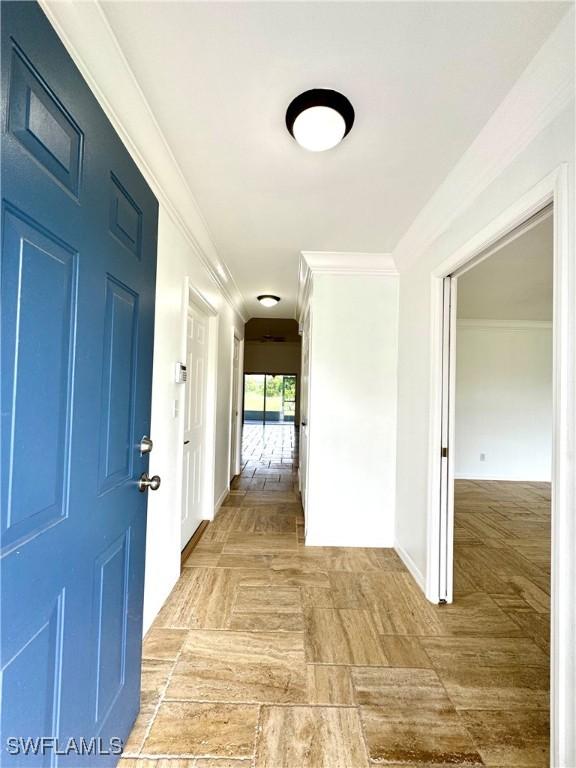 hallway featuring crown molding