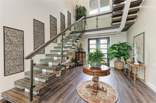 entryway featuring a high ceiling, dark wood-type flooring, and french doors