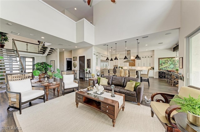 living room with a high ceiling and hardwood / wood-style flooring