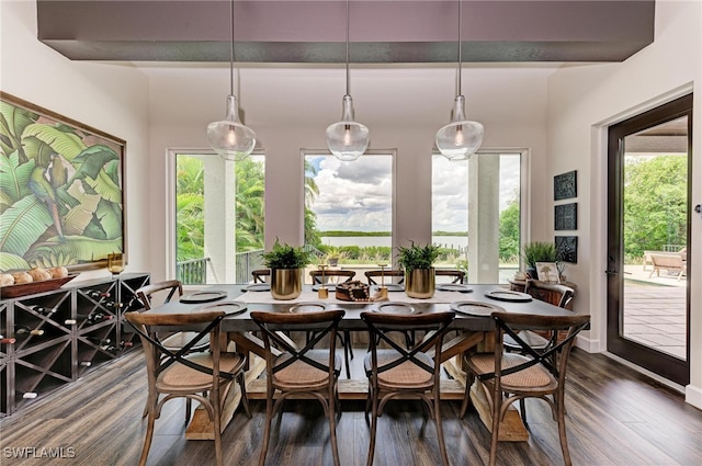 dining room with beam ceiling and dark wood-type flooring