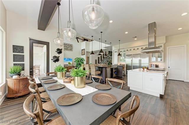 dining space featuring beam ceiling and dark hardwood / wood-style flooring