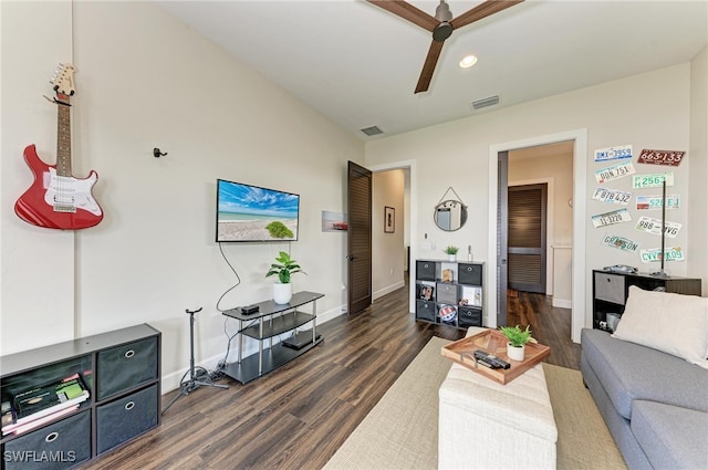 living room with ceiling fan and dark hardwood / wood-style flooring