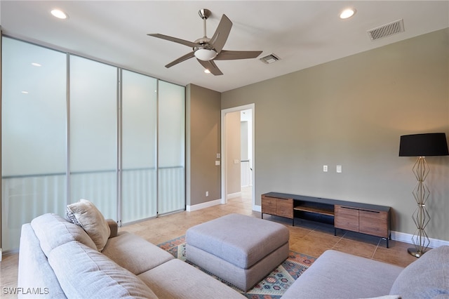 living room with ceiling fan and light tile patterned flooring