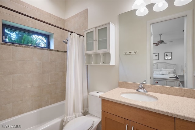 full bathroom featuring shower / tub combo, vanity, toilet, and ceiling fan