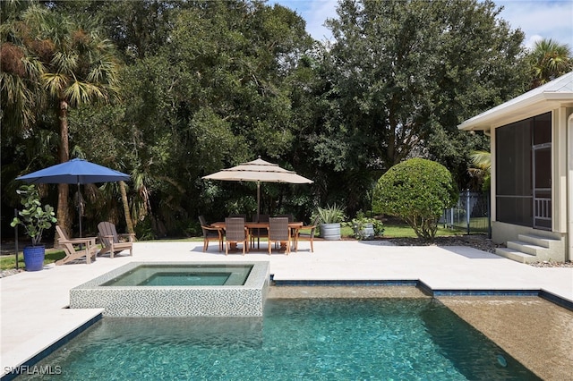 view of swimming pool with a sunroom, an in ground hot tub, and a patio