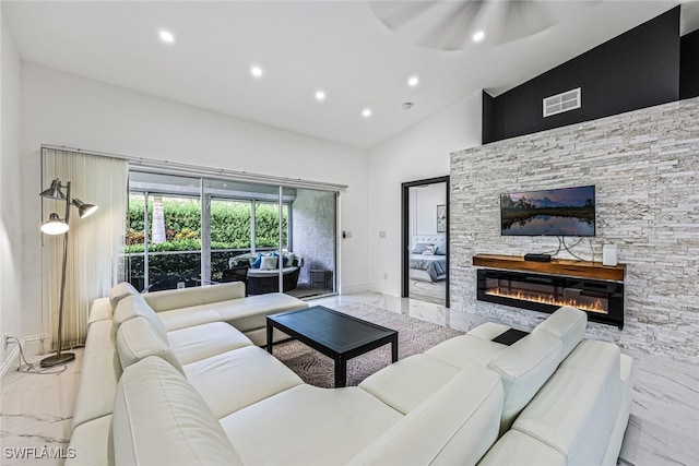 living room with high vaulted ceiling, ceiling fan, and a fireplace