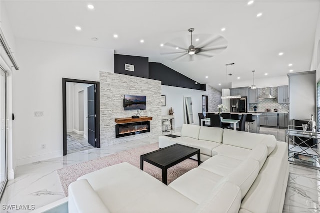 living room with high vaulted ceiling, ceiling fan, and a stone fireplace